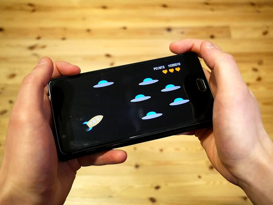 Мобильная игра на смартфоне в руках